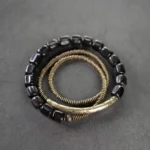 Ebony wood and antiqued copper three-strand Buddhist healing bracelet set - flat lay top view