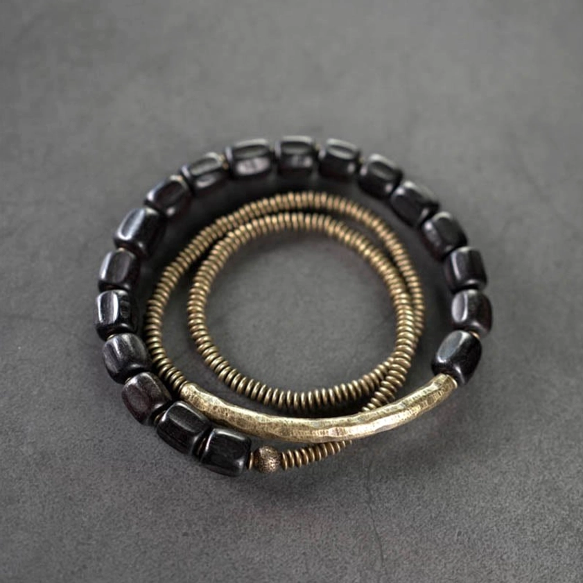 Ebony wood and antiqued copper three-strand Buddhist healing bracelet set - flat lay top view