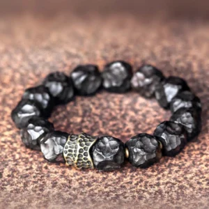Ebony wood copper couple bracelet with hammered antique bronze beads on brown leather background, spiritual protection jewelry