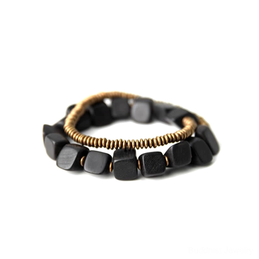Complete double wrap bracelet set in ebony wood and bronze copper displayed in flat lay composition on light background