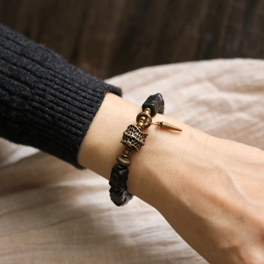 Man wearing dark ebony wood copper bracelet with bronze hardware showing masculine style and comfortable fit