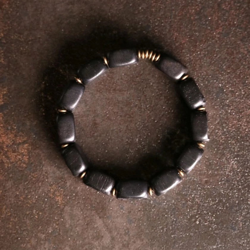 Complete ebony wood and copper square bead bracelet displayed in full circular form showing complete design