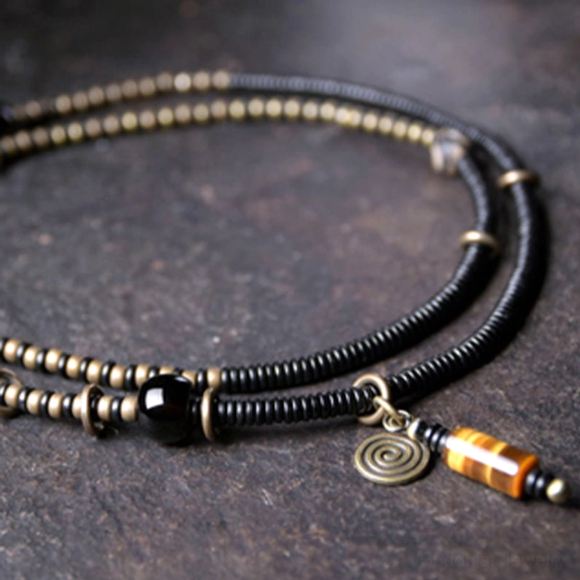 Dual-strand ebony wood dzi bead bracelet necklace overhead flat lay with tiger eye pendant accessory showing complete collection