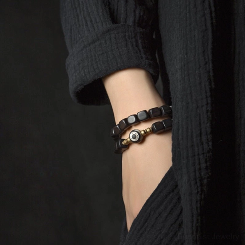 Ebony wood dzi bead bracelet worn on wrist, close-up side view showing delicate design