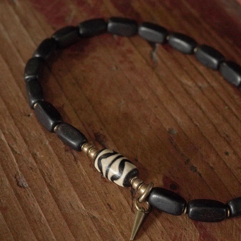 Multiple ebony dzi bead bracelets styled together showing versatile layering options