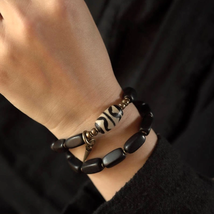 Ebony wood dzi bracelet double wrap showing protective energy amulet symbolism
