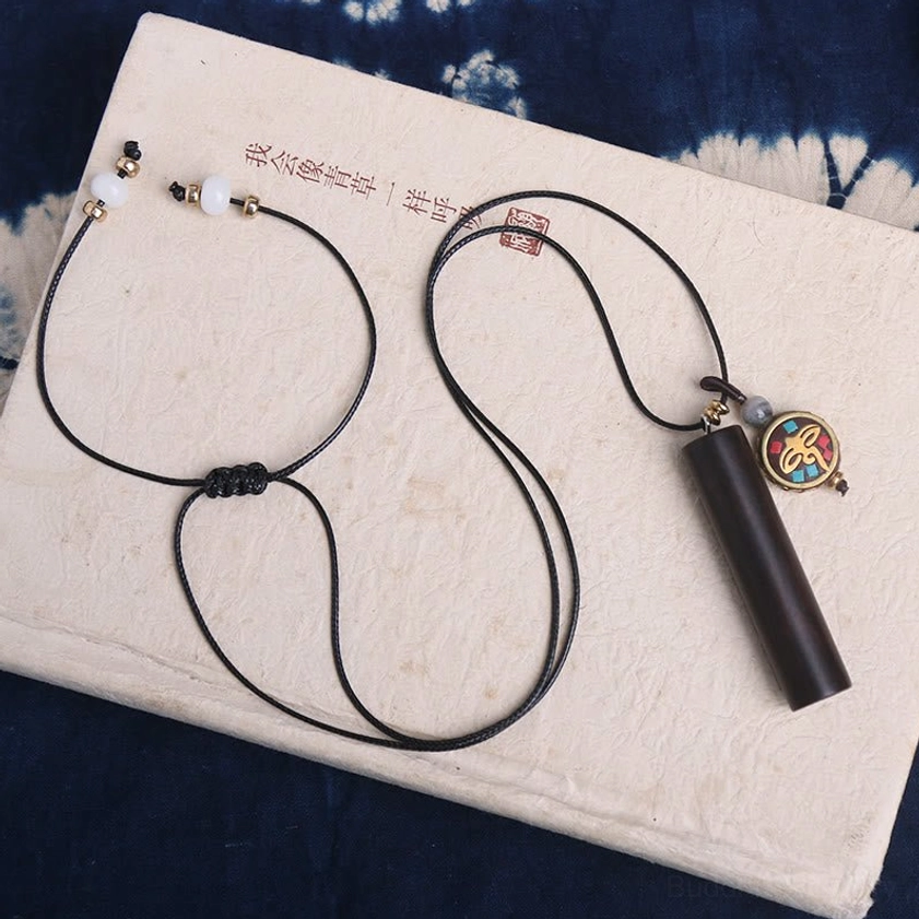 Matching pair of ebony wood round dzi charm necklaces with black wax cords and adjustable design