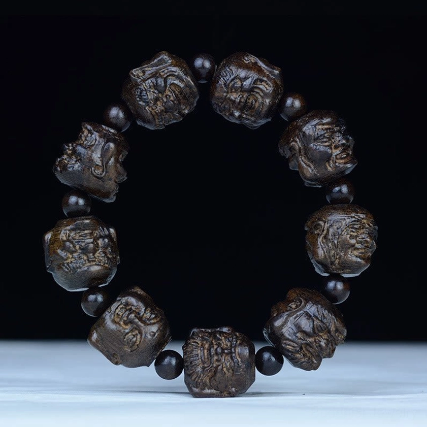 Eighteen Arhats carved ebony wood Buddhist bracelet, overhead view showing detailed arhat face engravings on 20mm beads with black spacers