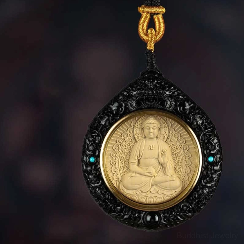 Seated Buddha pendant with swastika symbol carved in ebony wood with turquoise inlay