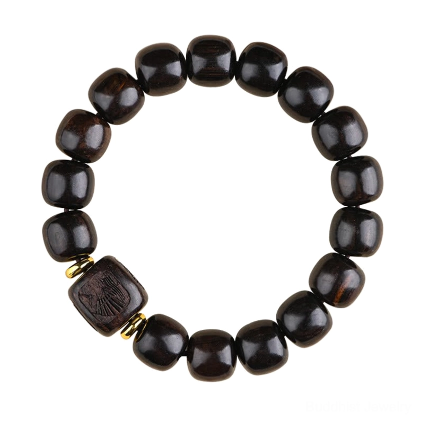 Overhead flat lay of circular ebony wood bracelet with carved square bead, gold spacers, and polished dark barrel beads
