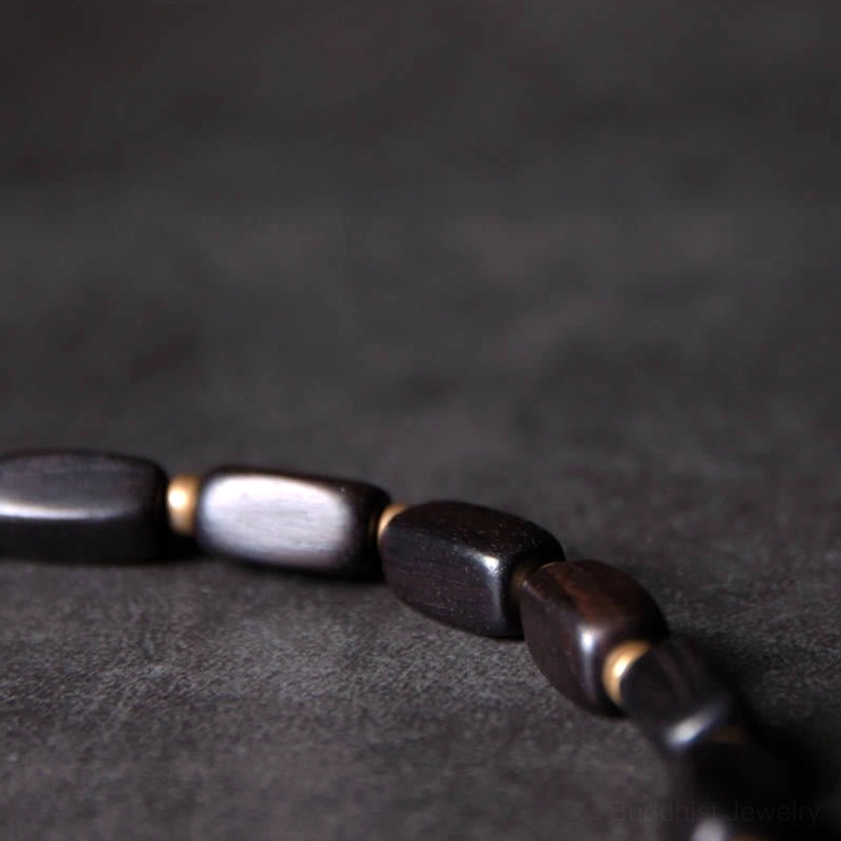 Ebony wood beads with bronze accents partial bracelet strand side view