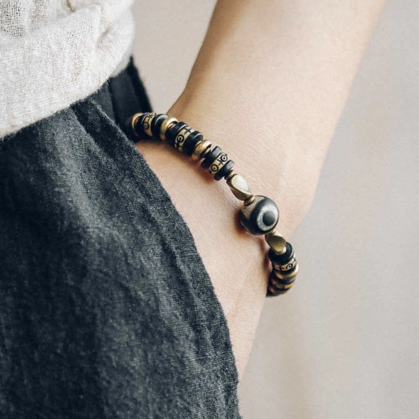 Buddhist bone beads bracelet worn on wrist with casual linen and denim outfit, demonstrating daily wear style and elegant aesthetic