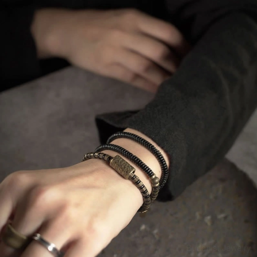 Black ebony wood beaded spiritual bracelet showing natural wood grain texture and handcrafted copper elements