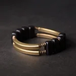 Double-layer ebony wood and brass Buddhist bracelet with parallel metal bars and square wooden beads, top-down view