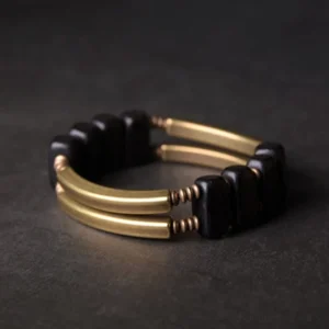 Double-layer ebony wood and brass Buddhist bracelet with parallel metal bars and square wooden beads, top-down view