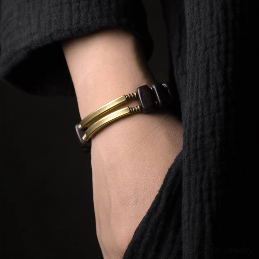 Ebony wood and brass Buddhist bracelet worn on wrist showing side profile fit and comfortable wear