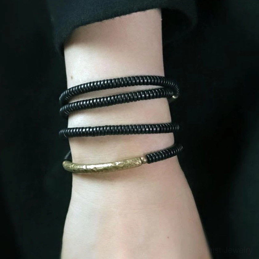 Ebony wood Buddhist bracelet worn on wrist, demonstrating comfortable multi-wrap fit and styling