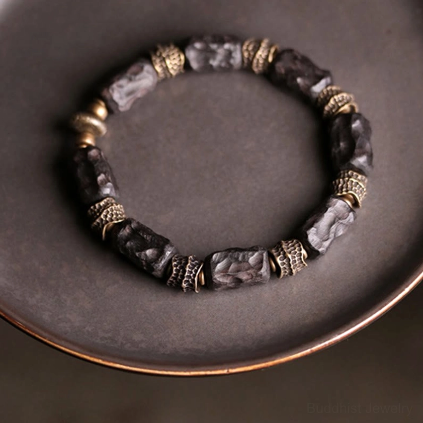 Ebony wood and copper Buddhist bracelet overhead angle showing bead spacing