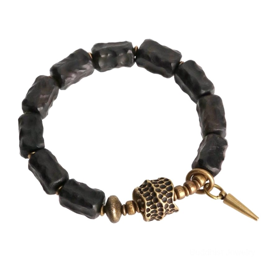 Full view ebony wood copper spiritual bracelet with antique bronze hardware and spike pendant on white background