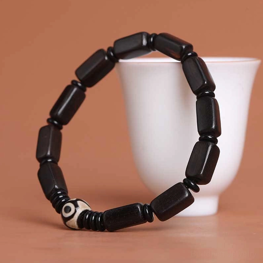 Full product shot of ebony wood Dzi bead Buddhist bracelet for spiritual protection and daily mindfulness wear
