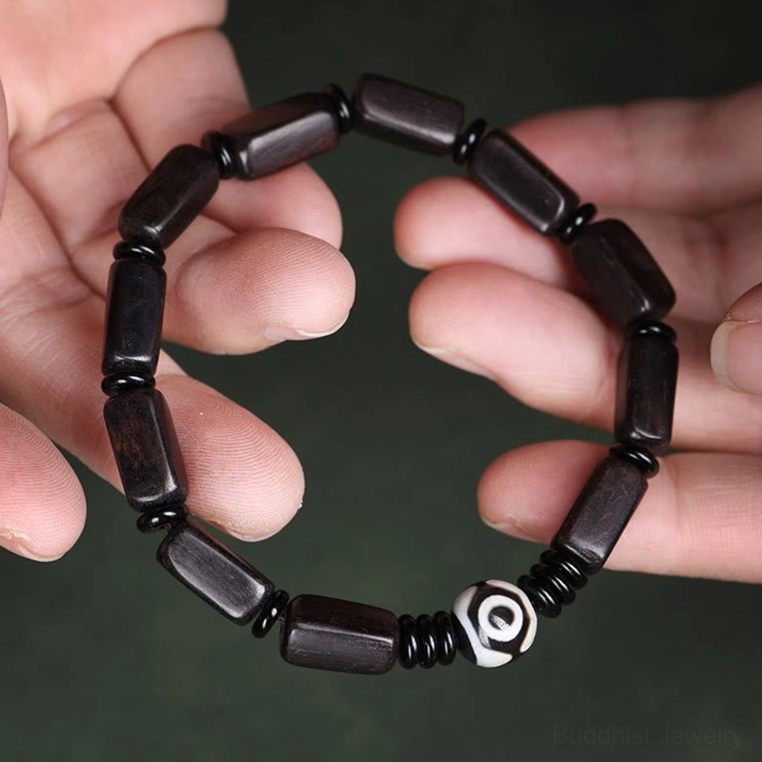 First-person view of ebony wood Dzi bead bracelet worn on wrist, full bracelet design demonstration for daily wear