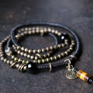 Ebony wood dzi bead copper peace bracelet necklace pendant flat lay overhead view showing multi-layer beaded design with nine-eye dzi bead