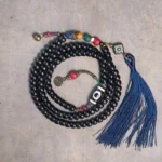 108 bead ebony wood mala bracelet with hand-painted dzi bead and navy blue tassel - flat lay display