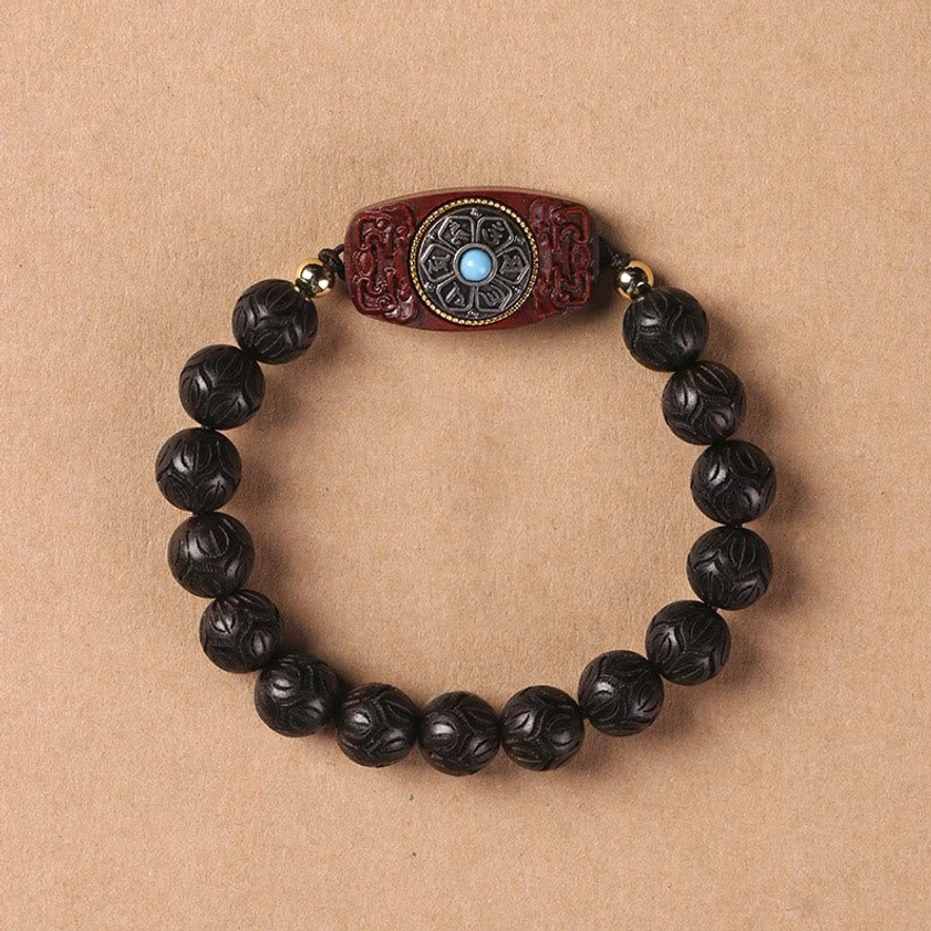 Ebony wood mala bracelet showing smooth dark finish and spiritual protection properties