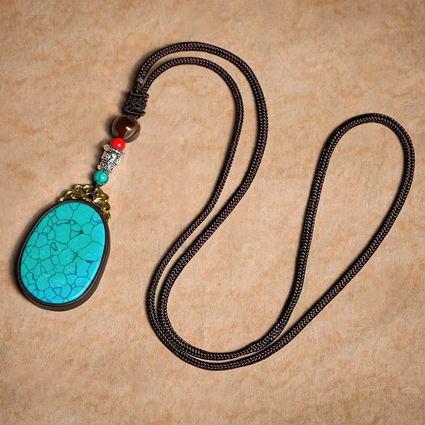 Ebony wood cracked stone necklace worn lifestyle shot showing spiritual balance and protection benefits
