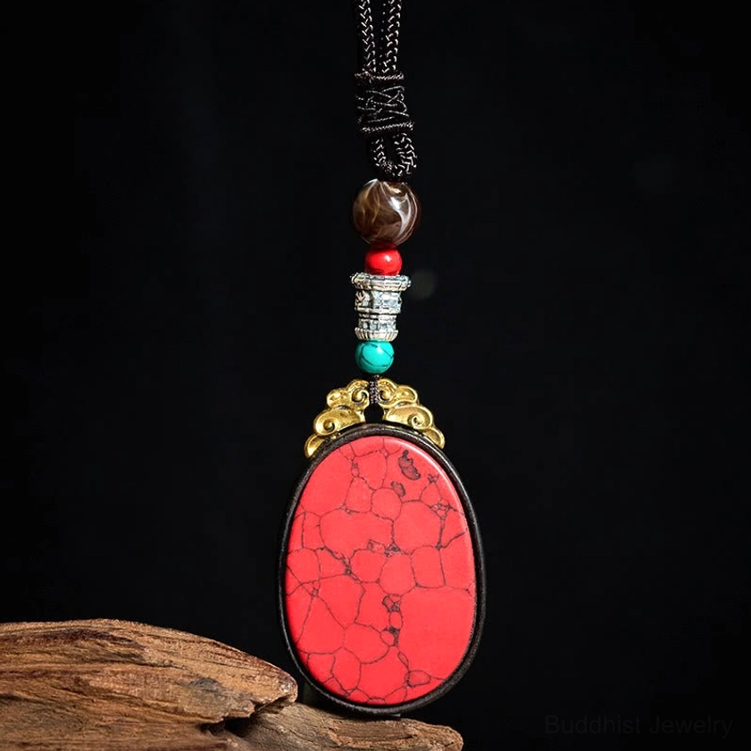 Red cracked stone ebony wood necklace with copper alloy hardware and decorative beads, artistic flat lay display
