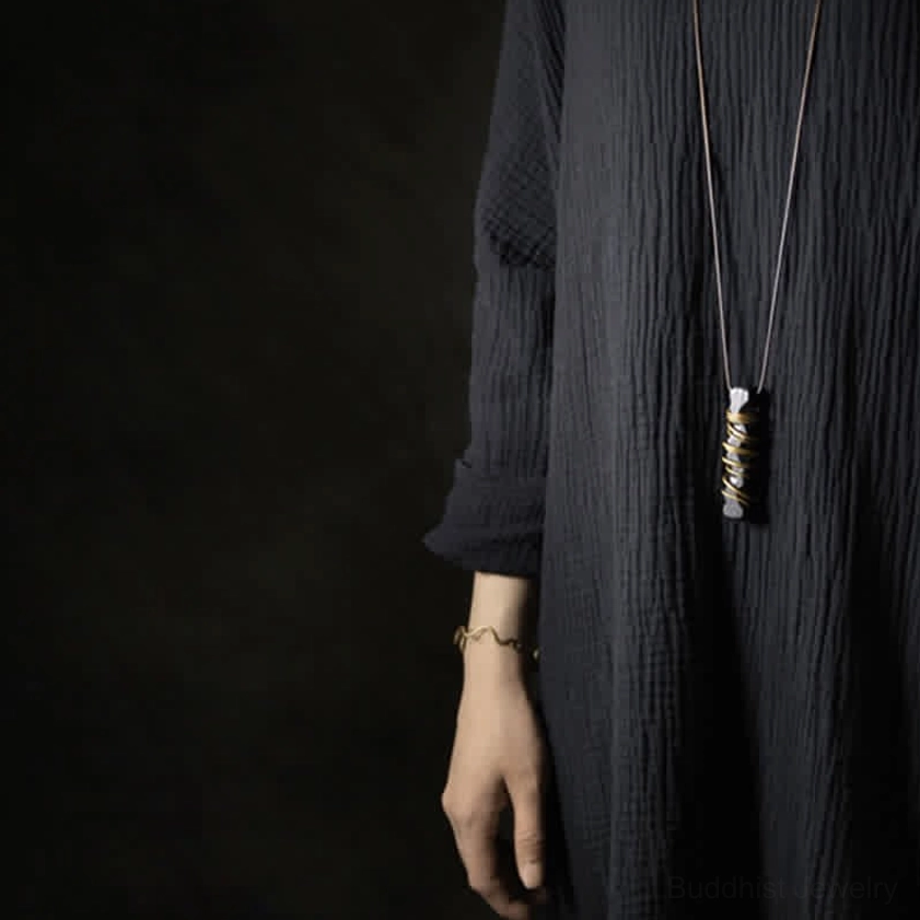 Ebony wood zen circle brass necklace pendant artistic product photography spiritual jewelry