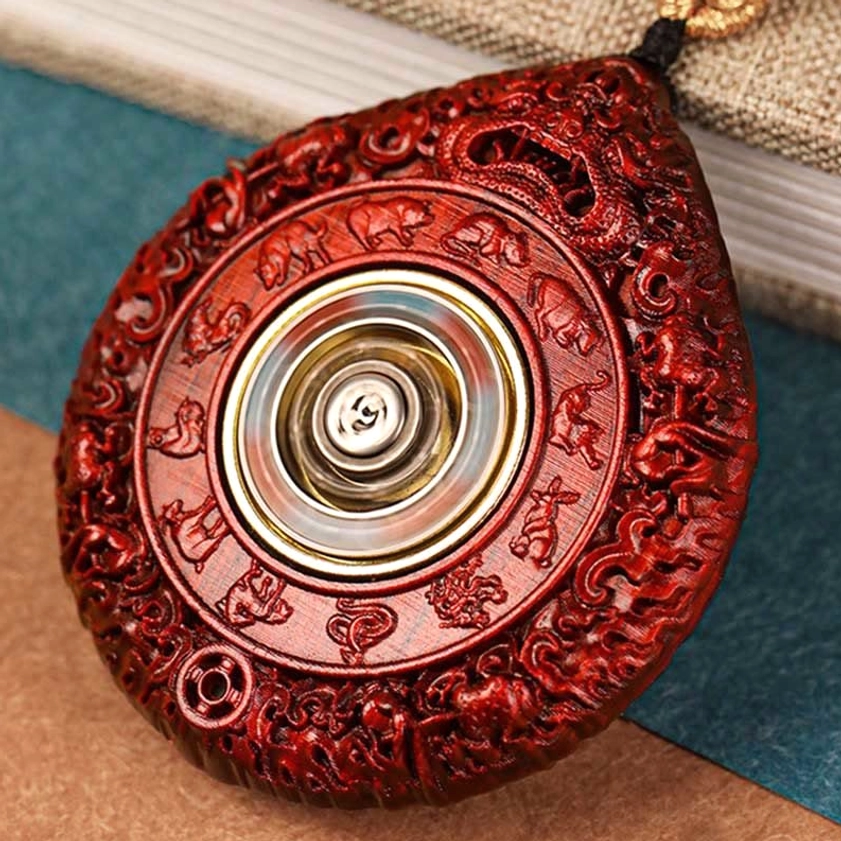 Ebony wood zodiac Buddha necklace pendant showing hand-carved relief detail