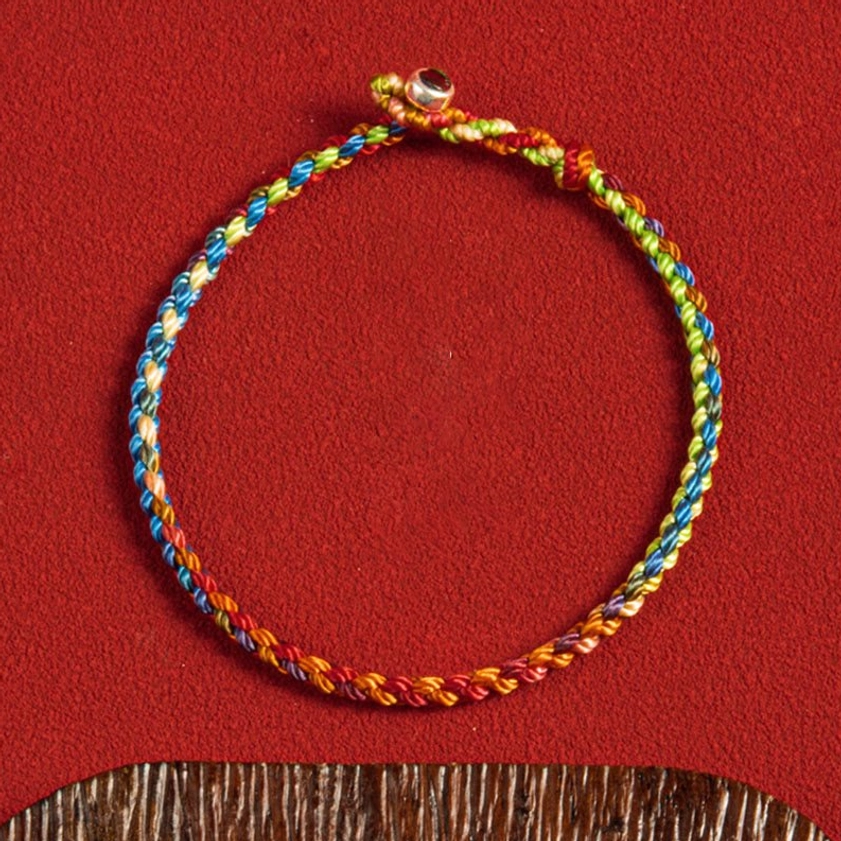 Eco-friendly handcrafted Buddhist bracelet with multicolored cord and sustainable materials, conscious gift option