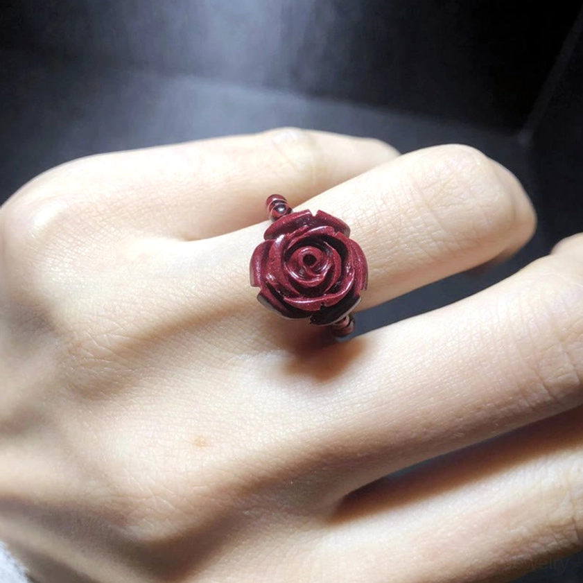 Eco-friendly handcrafted cinnabar Buddhist ring with garnet and protective symbols, showcasing natural material authenticity and artisanal quality