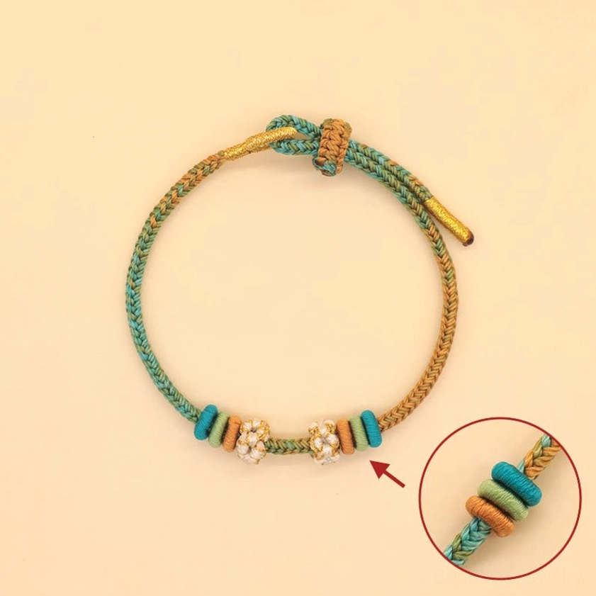 Eight-thread braided luck bracelet flat lay with magnified knot detail showing craftsmanship