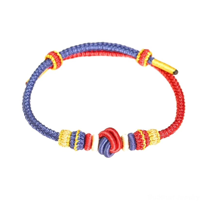 Red blue and gold braided Buddhist bracelet front view with traditional eight-thread knot on white background