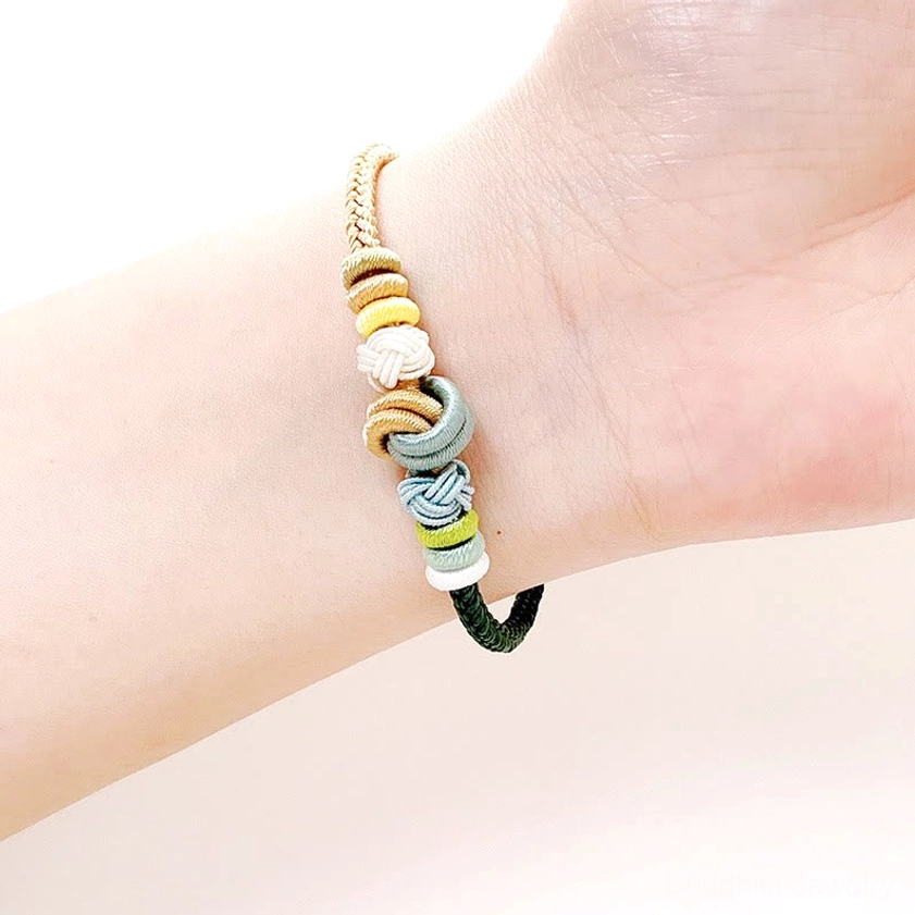 Eight-thread peace knot Buddhist protection bracelet close-up detail showing handcrafted braided cord and sacred knot