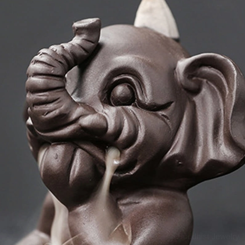 Purple clay elephant incense burner ceremonial use showing Buddhist ritual practice and spiritual observance