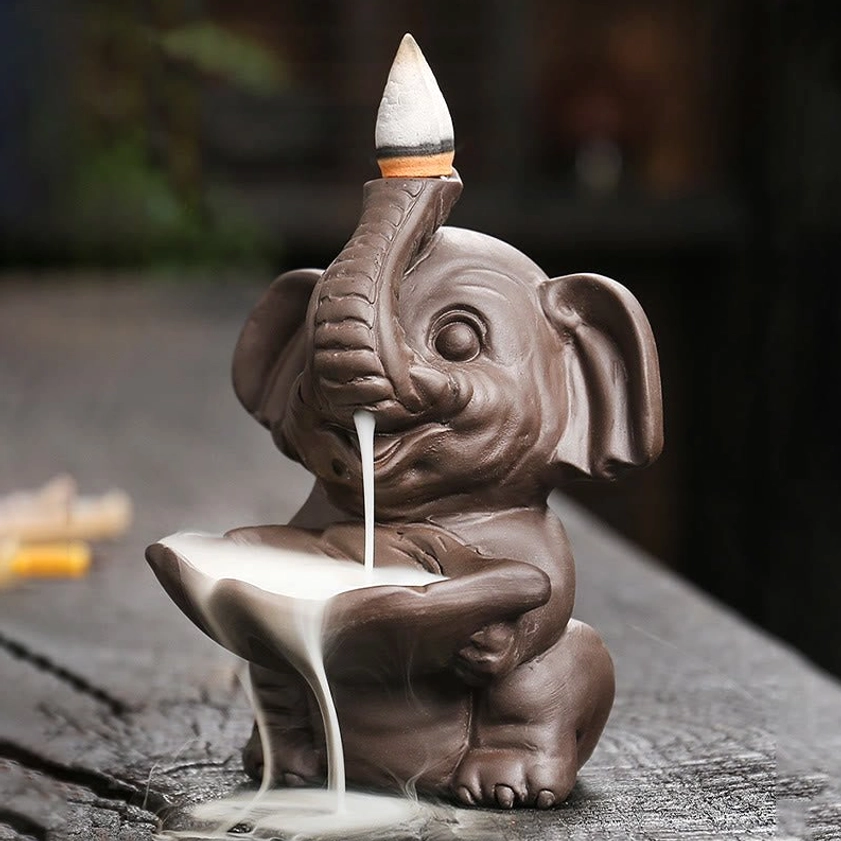Left side perspective of purple clay elephant backflow incense burner with smooth finish and active smoke flow