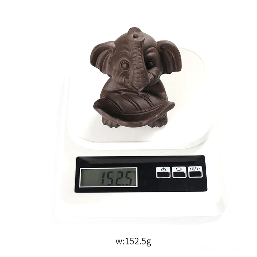 Purple clay elephant backflow incense fountain creating meditation atmosphere in wellness space
