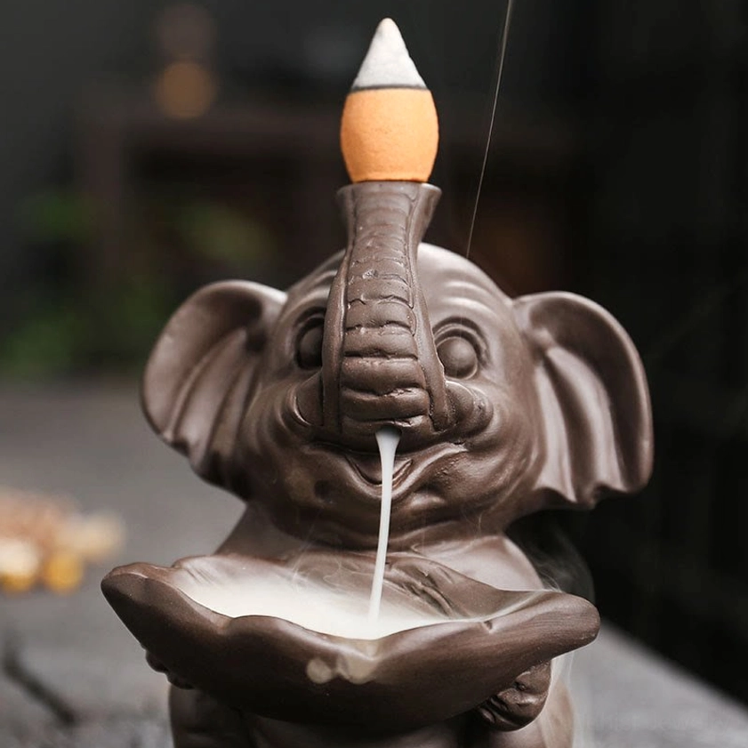Purple clay elephant backflow incense burner lifestyle shot in meditation space setting