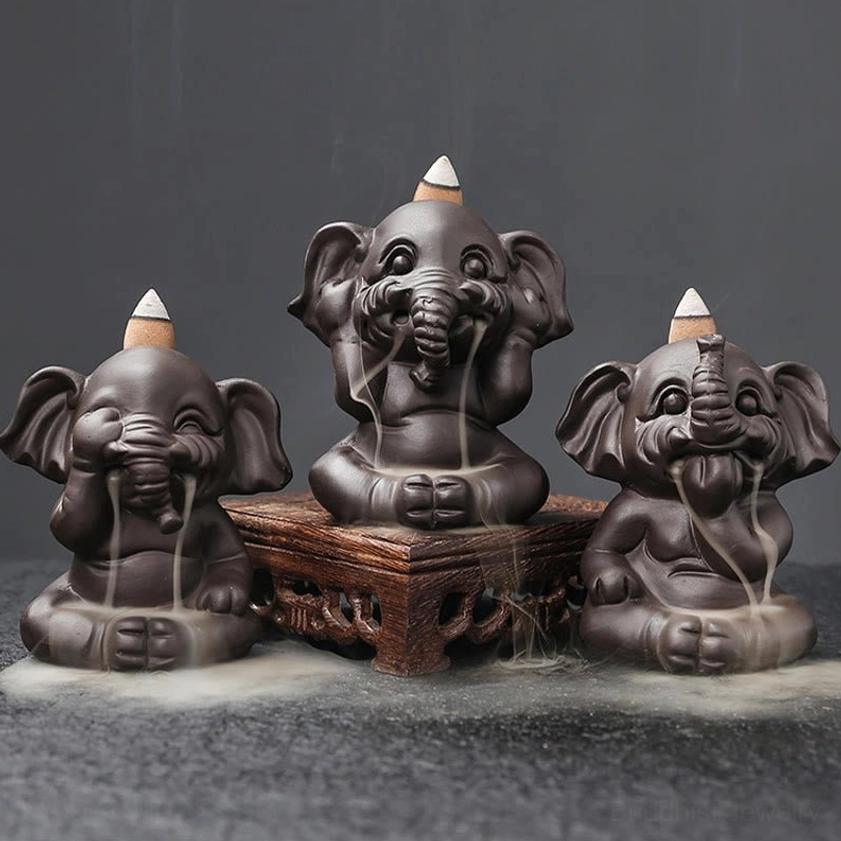 Three handcrafted ceramic elephant incense burners displayed on wooden base with artistic smoke decoration, showing unique mudra gestures
