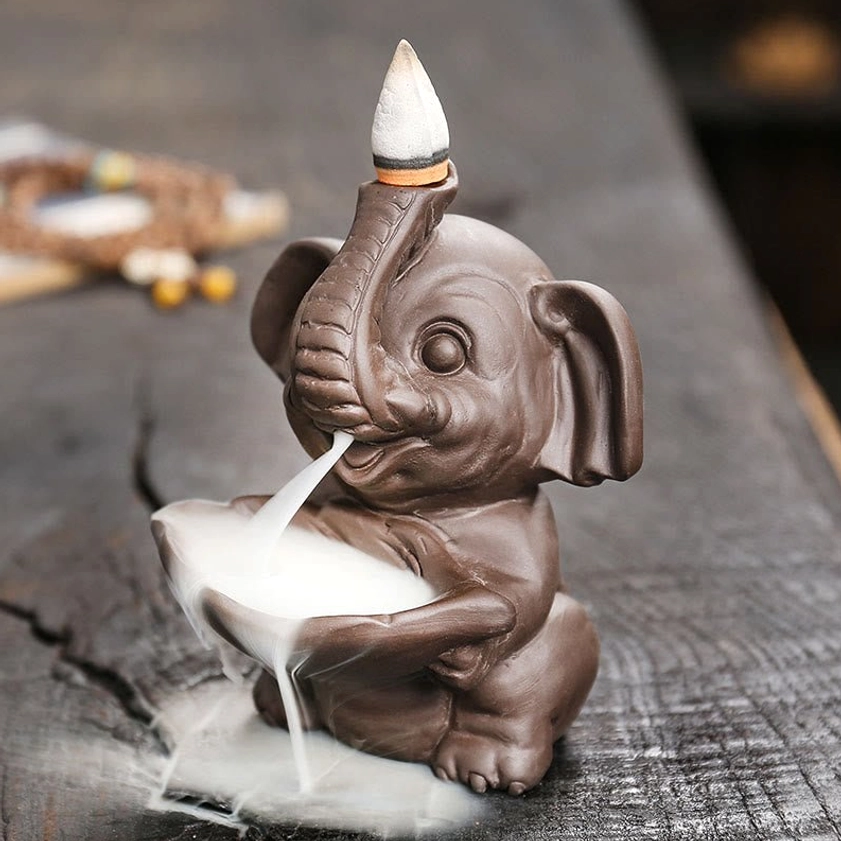 Right side angle of purple clay elephant incense holder with smoke tray and cascading backflow smoke