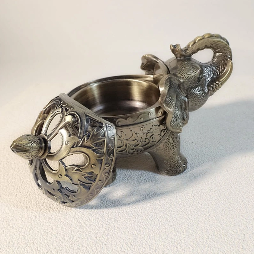 Multiple elephant incense holder style variations showing different antique bronze and brass finish options