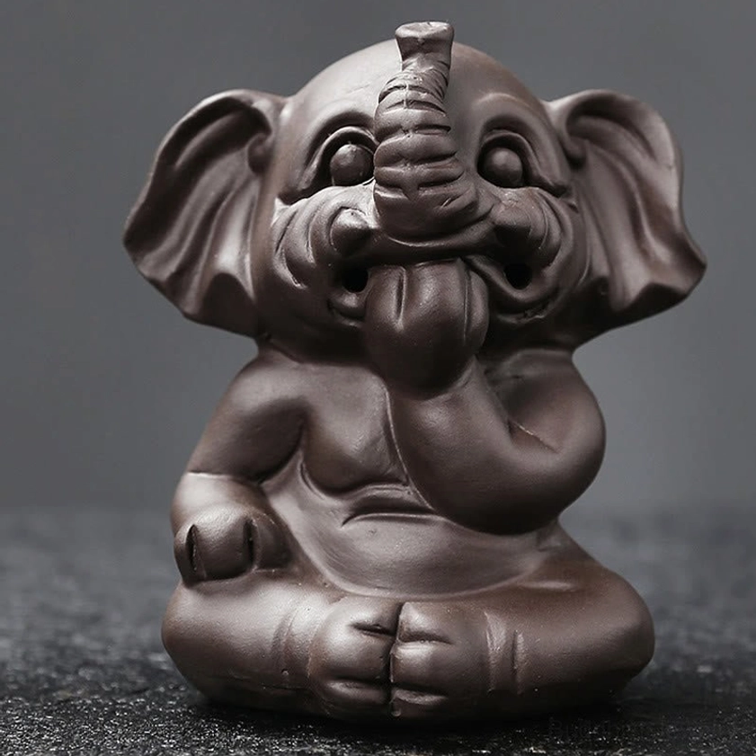 Handcrafted elephant incense burner top view showing incense cone slot opening and sculptural head detail