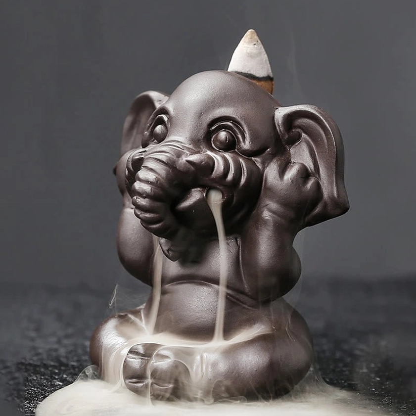 Elephant incense burner functional demonstration showing incense cone placement and proper usage instructions