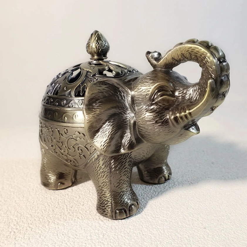 Handcrafted elephant incense holder showing artisan bronze alloy construction and traditional Eastern spiritual design