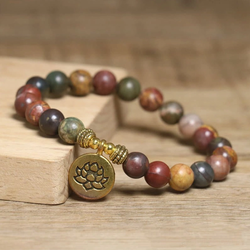 Buddhist meditation bracelet made of Emperor Stone beads with ornate lotus charm, handcrafted natural stone jewelry side view