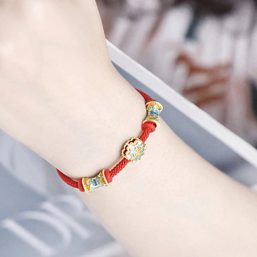 Sterling silver enamel beads close-up on red rope bracelet showing artisan craftsmanship