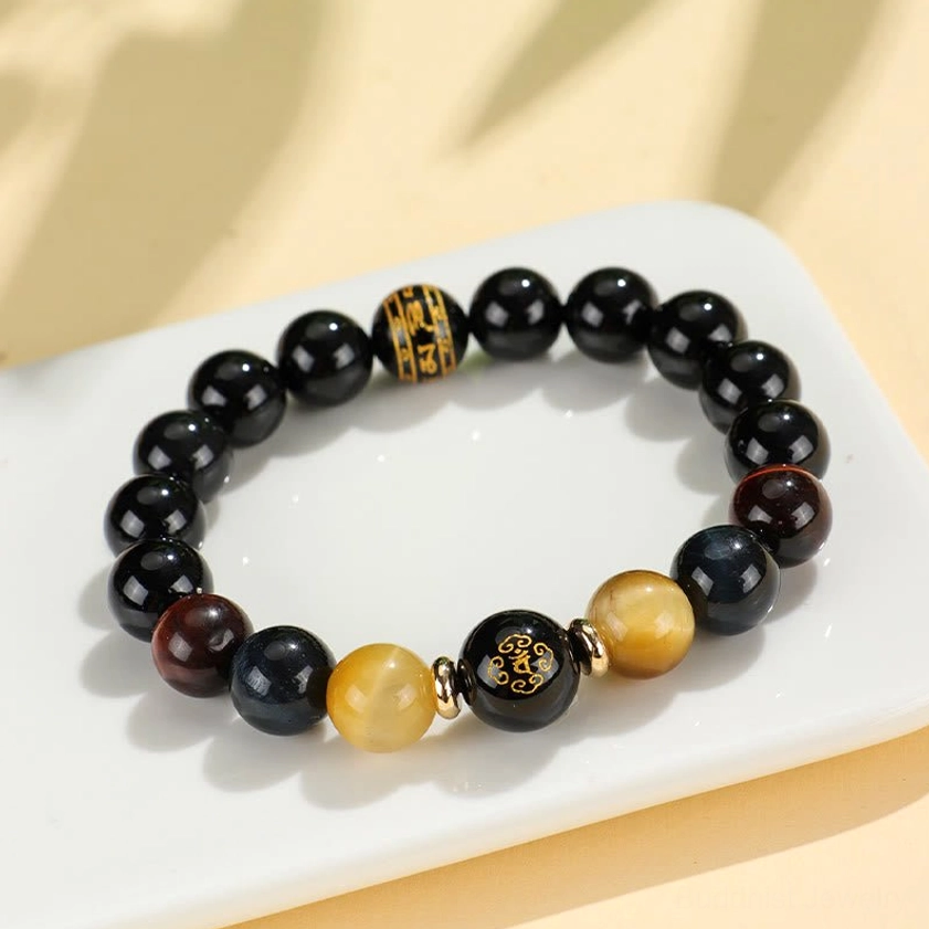 Black onyx tiger eye bracelet with engraved mantra bead and spiritual zodiac Buddha charm detail